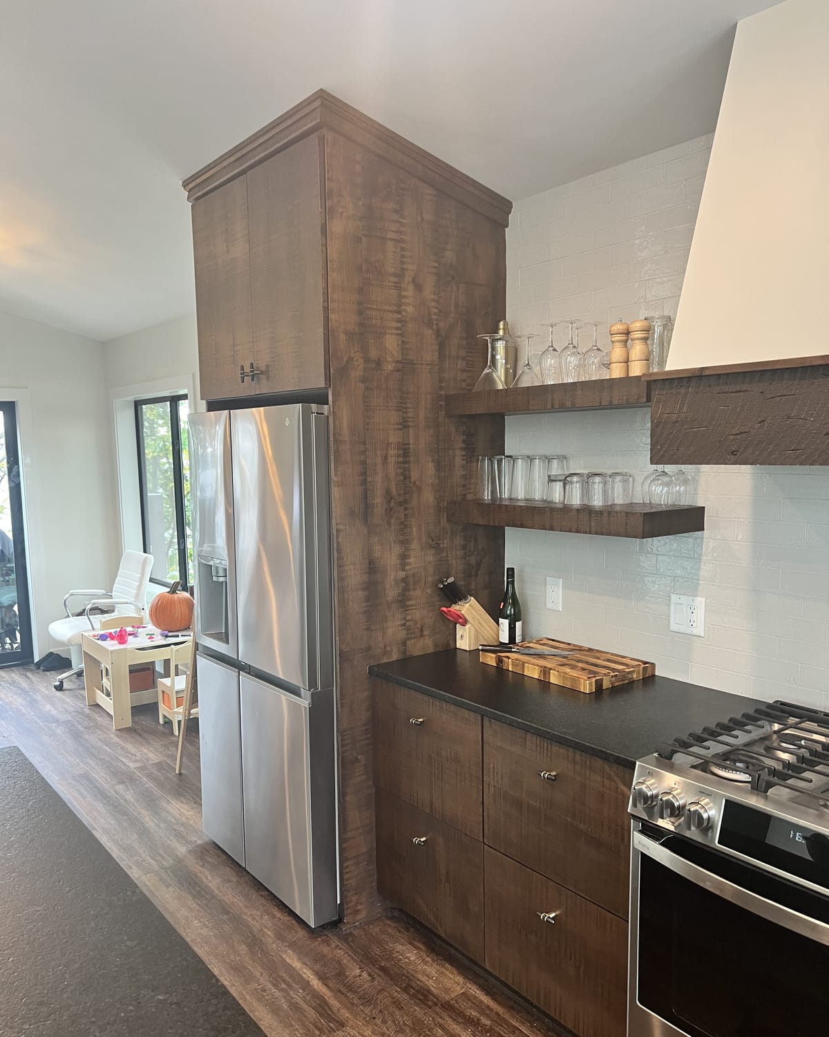 The kitchen: dark cabinetry and black stone counters.